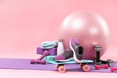 Photo of Many different sports equipment on pink background, space for text