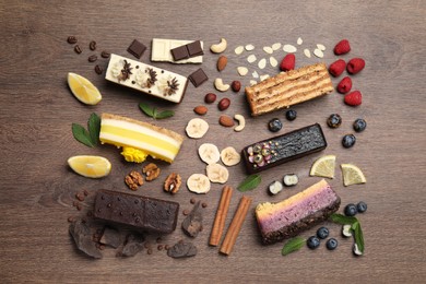 Photo of Flat lay composition with different tasty cakes on wooden table