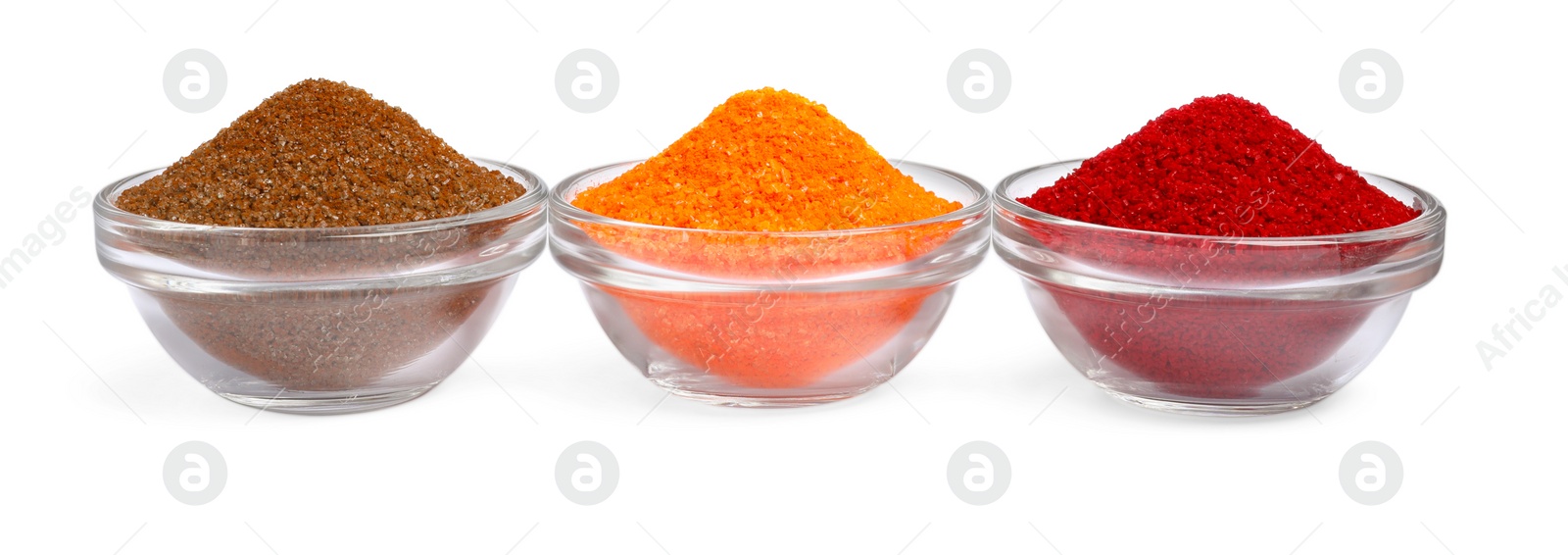 Photo of Glass bowls with different food coloring isolated on white