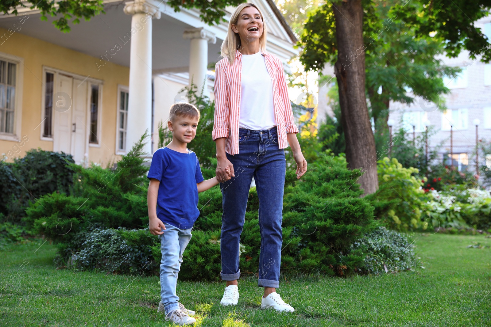 Photo of Nanny with cute little boy together on sunny day