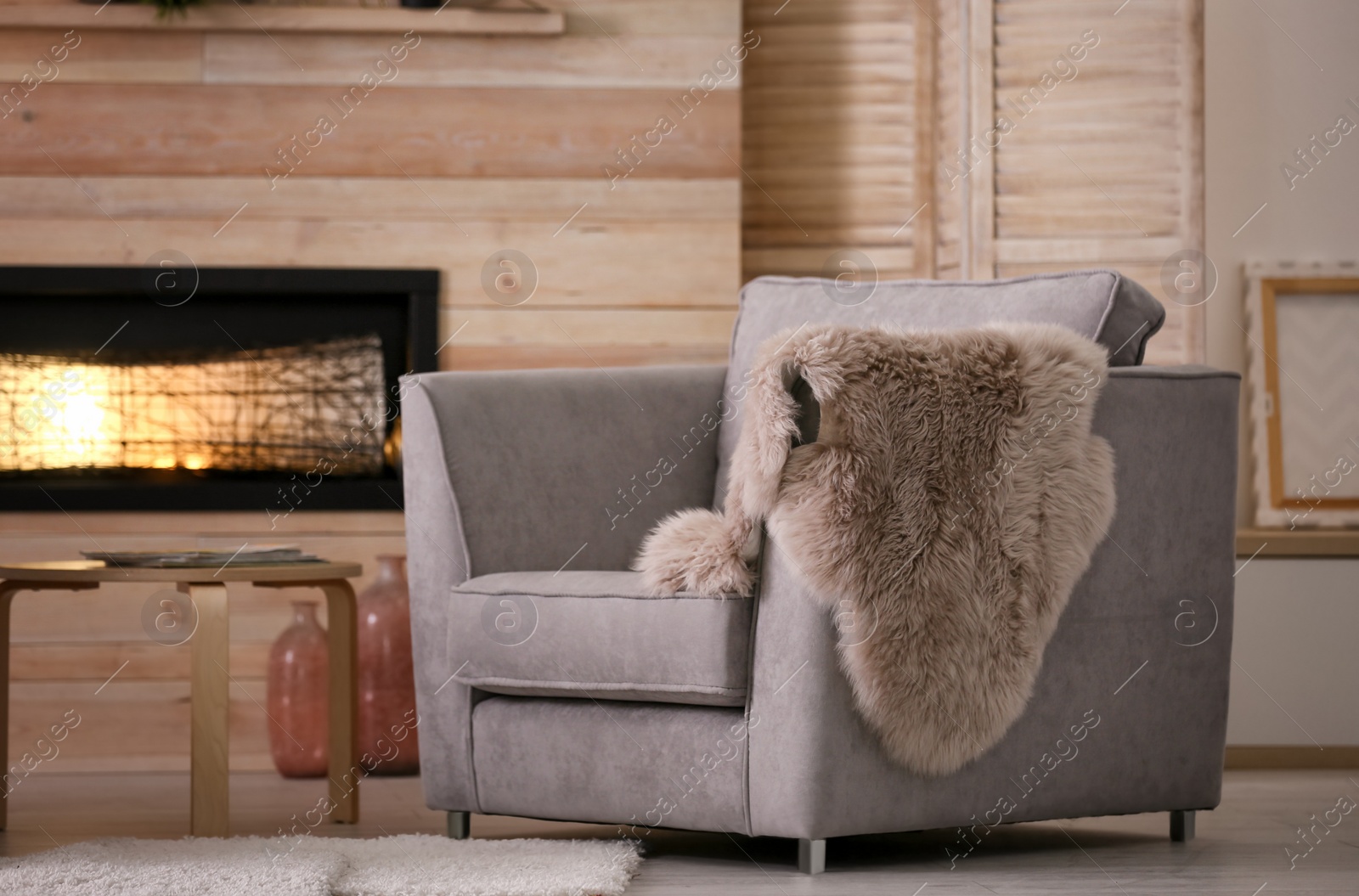 Photo of Cozy living room interior with comfortable armchair and decorative fireplace