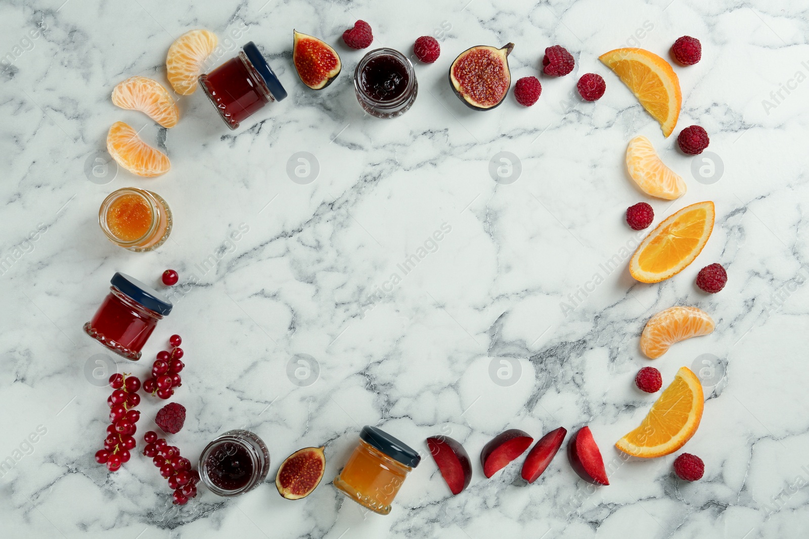 Photo of Frame of different jams and ingredients on white marble table, flat lay. Space for text