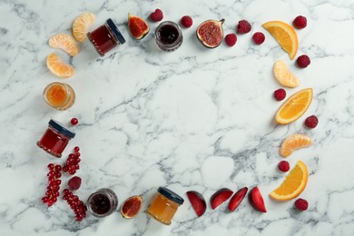 Frame of different jams and ingredients on white marble table, flat lay. Space for text