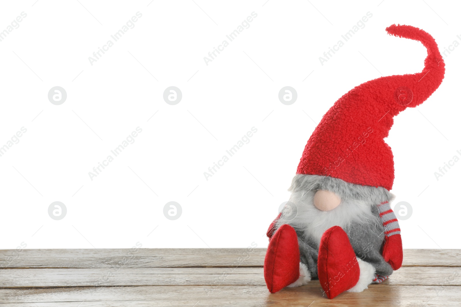 Photo of Funny Christmas gnome on wooden table against white background. Space for text