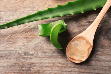 Flat lay composition with aloe vera on wooden background