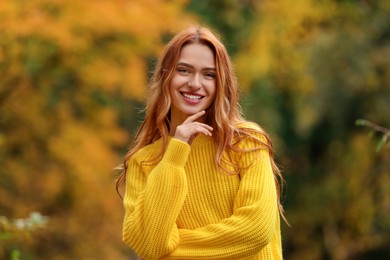 Portrait of happy woman in autumn park