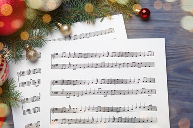 Photo of Flat lay composition with Christmas music sheets on blue wooden background