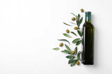 Flat lay composition with bottle of olive oil and space for text on light background