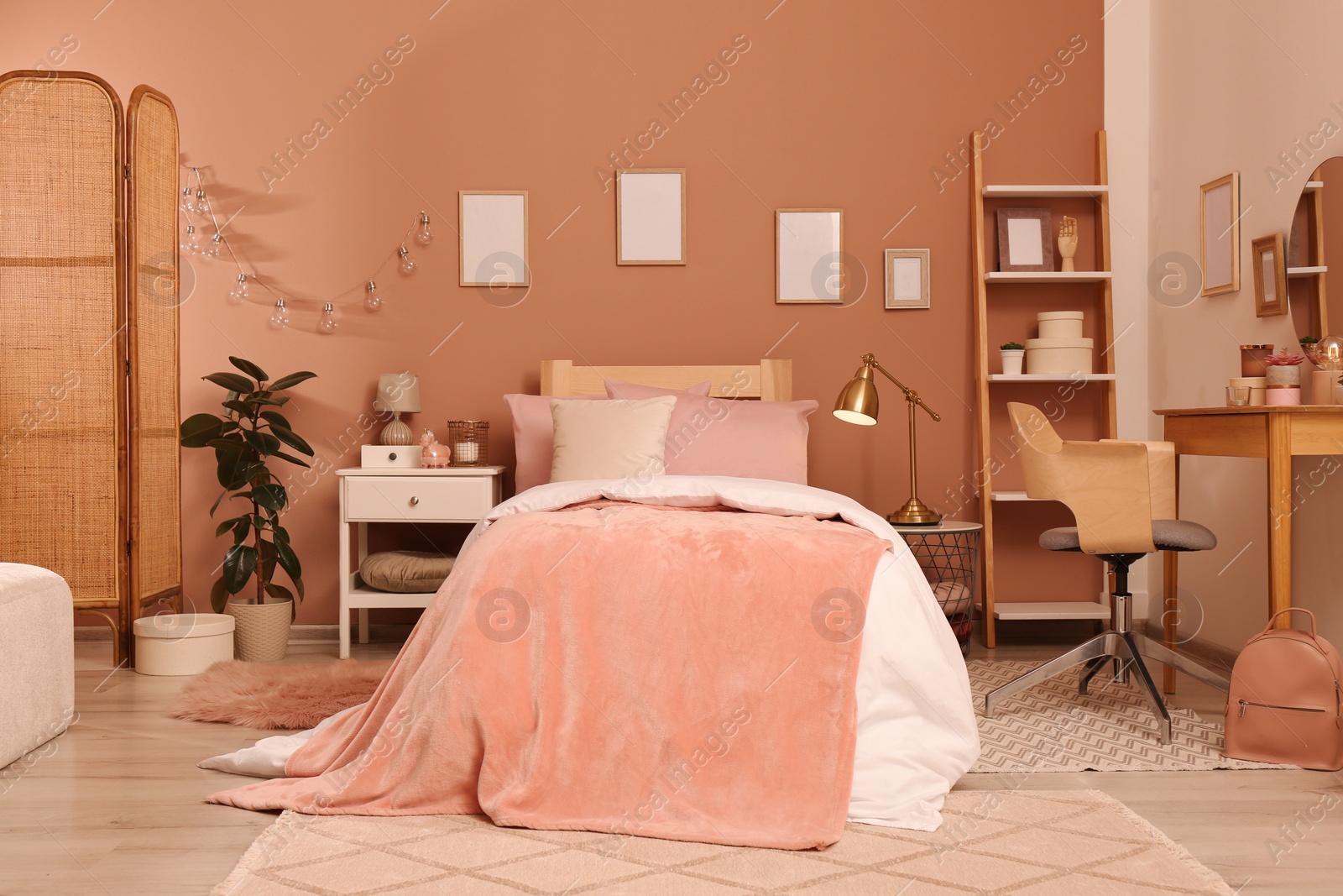 Photo of Teenage girl's bedroom interior with stylish furniture and beautiful decor elements