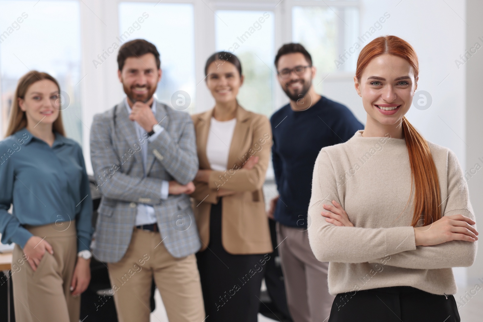 Photo of Portrait of happy businesswoman and her team in office