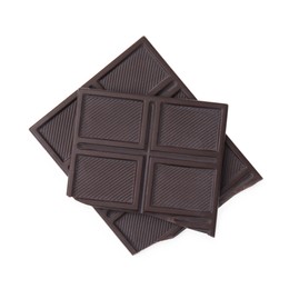 Photo of Pieces of tasty dark chocolate bar isolated on white, top view