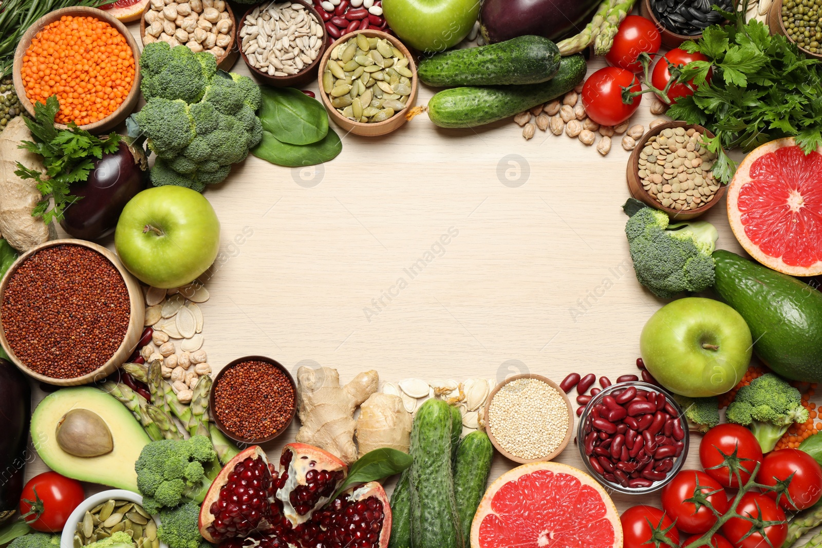 Photo of Frame of fresh vegetables, fruits and seeds on light table, flat lay. Space for text