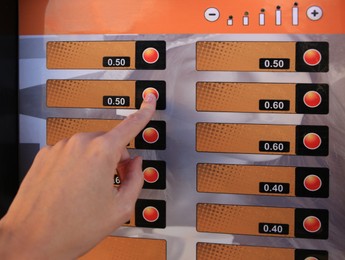 Image of Using coffee vending machine. Woman pressing button to choose drink, closeup