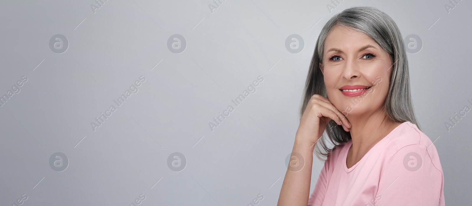 Image of Portrait of beautiful mature woman on light grey background. Banner design with space for text