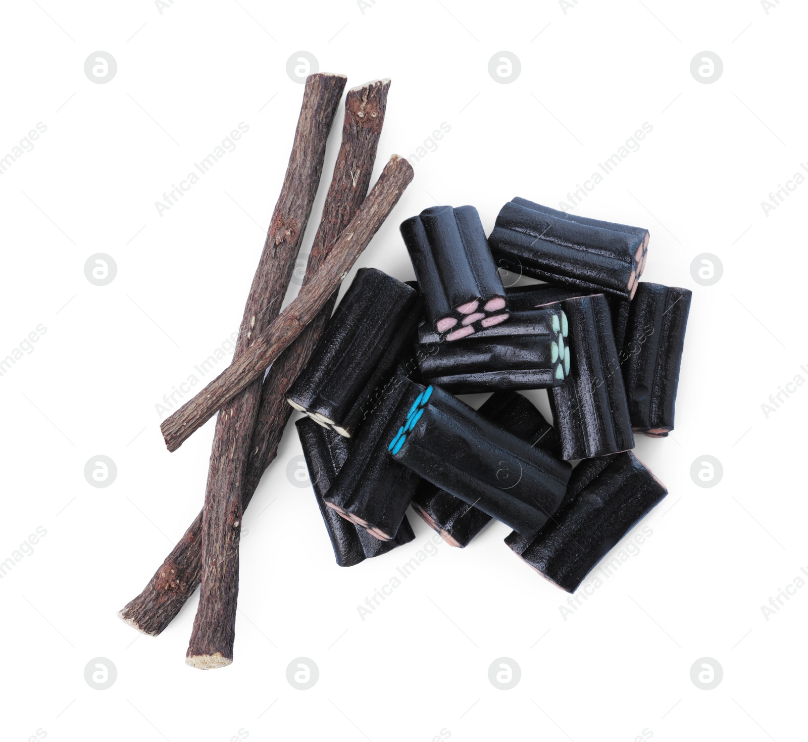 Photo of Many tasty candies and dried sticks of liquorice root isolated on white, top view