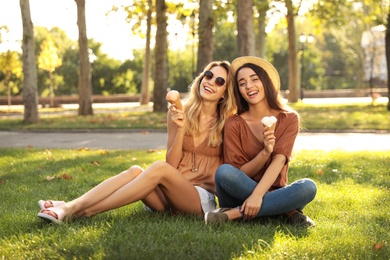 Young women with ice cream spending time together outdoors