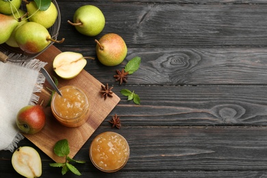 Delicious pear jam and fresh fruits on black wooden table, flat lay. Space for text