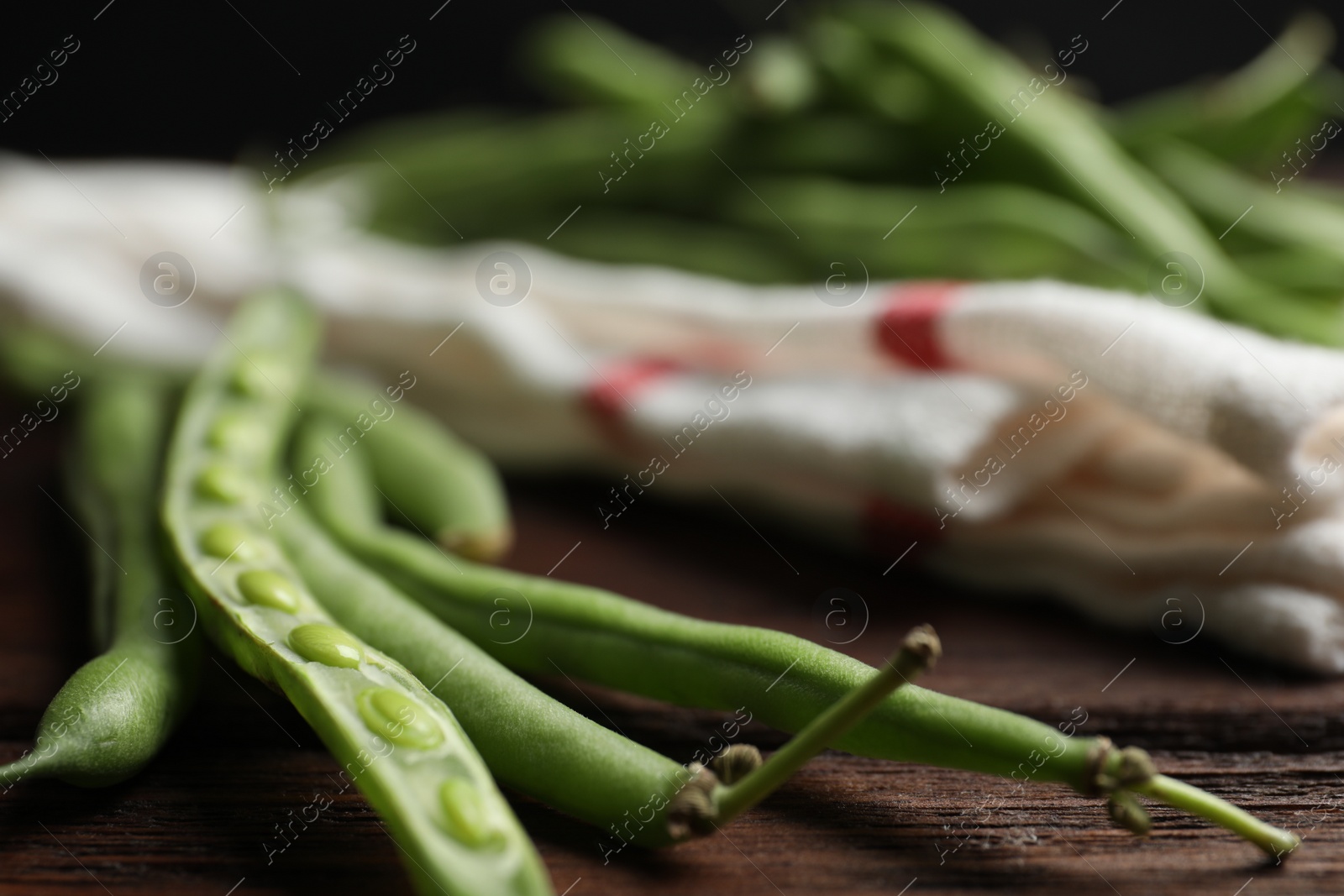 Photo of Fresh green beans on wooden table, closeup