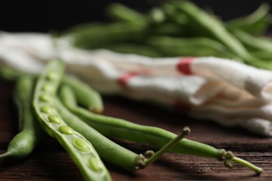 Fresh green beans on wooden table, closeup