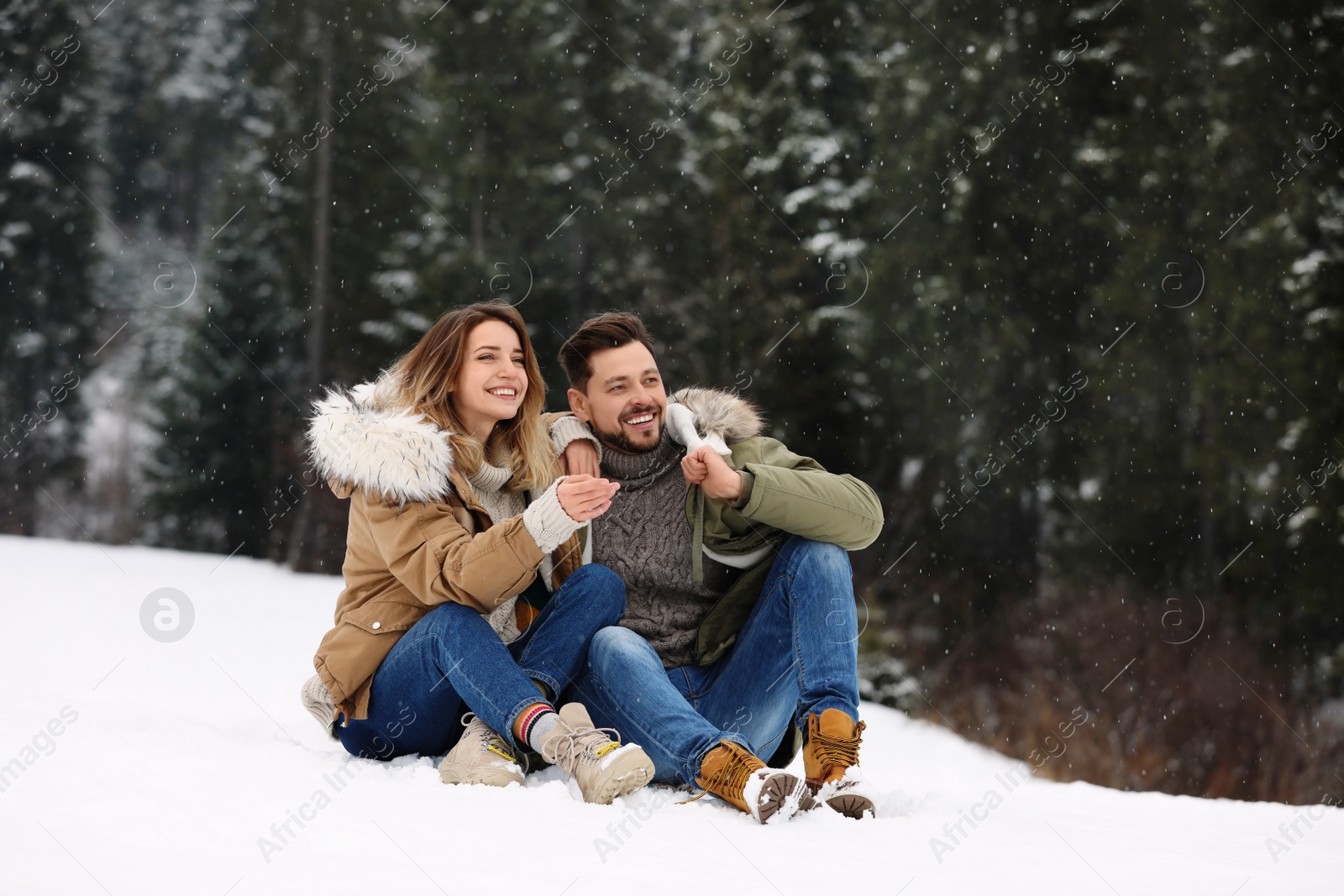 Photo of Couple spending time outdoors on snowy day. Winter vacation