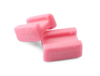 Photo of Tasty pink chewing gums on white background