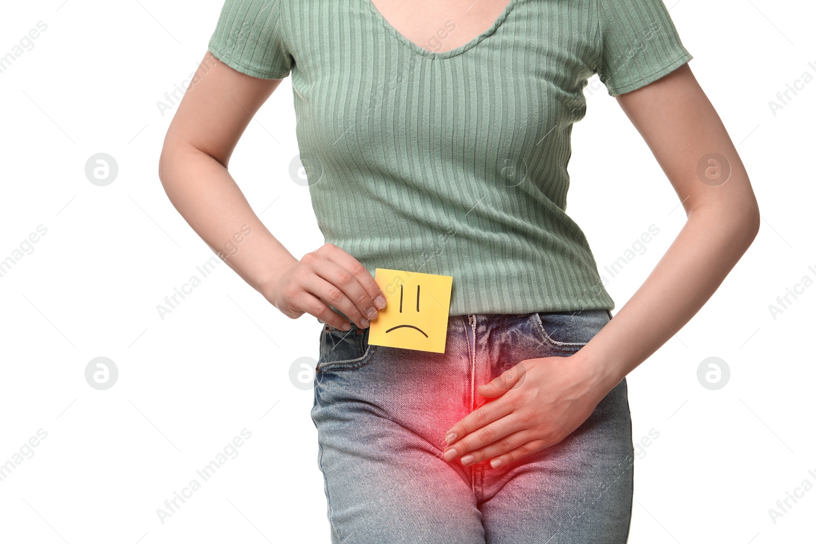 Image of Woman holding sticky note with drawn sad face and suffering from cystitis symptoms on white background, closeup