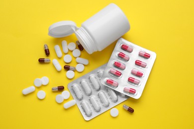 Photo of Different antidepressants on yellow background, flat lay