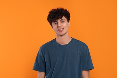 Portrait of handsome young man on orange background