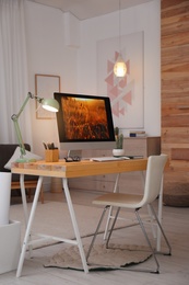 Photo of Comfortable workplace with modern computer on desk. Home office