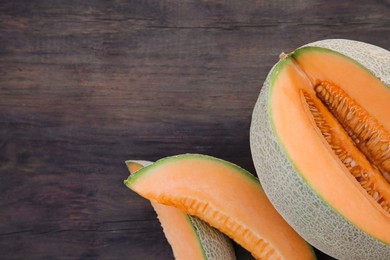 Photo of Cut delicious ripe melon on wooden table, flat lay. Space for text