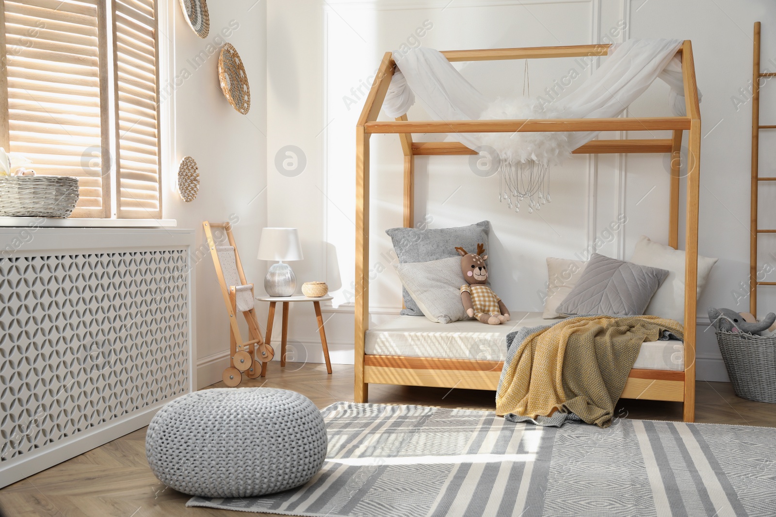 Photo of Stylish child room interior with house bed