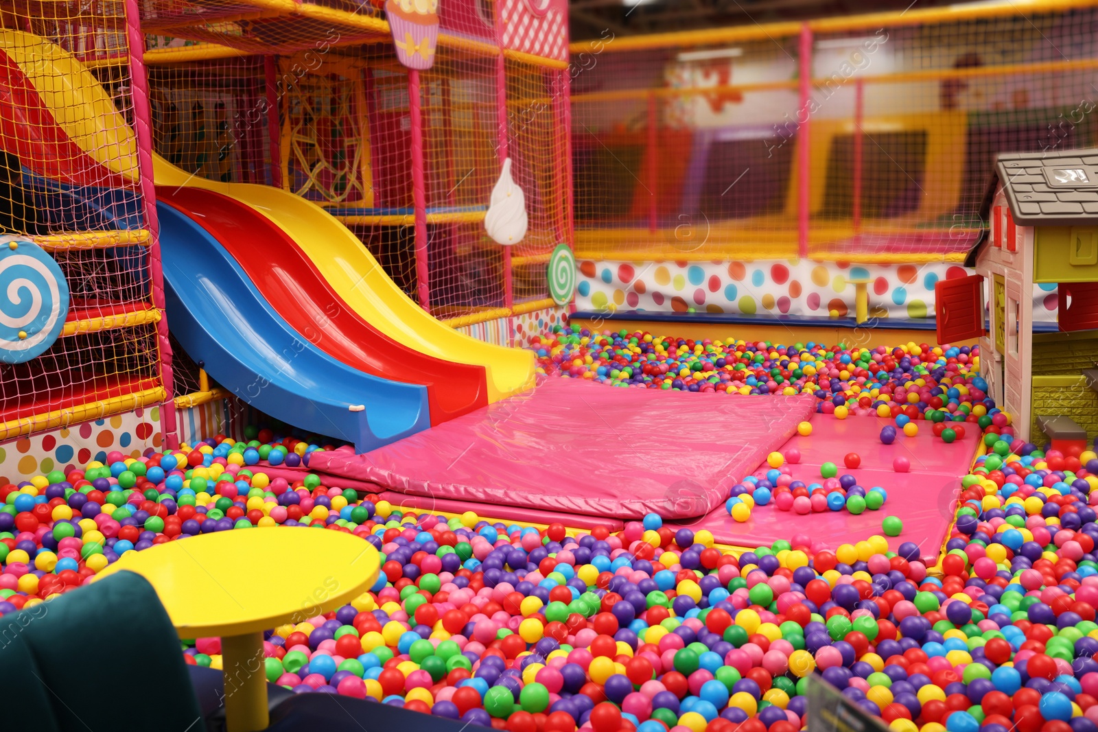 Photo of Slides and many colorful balls in ball pit