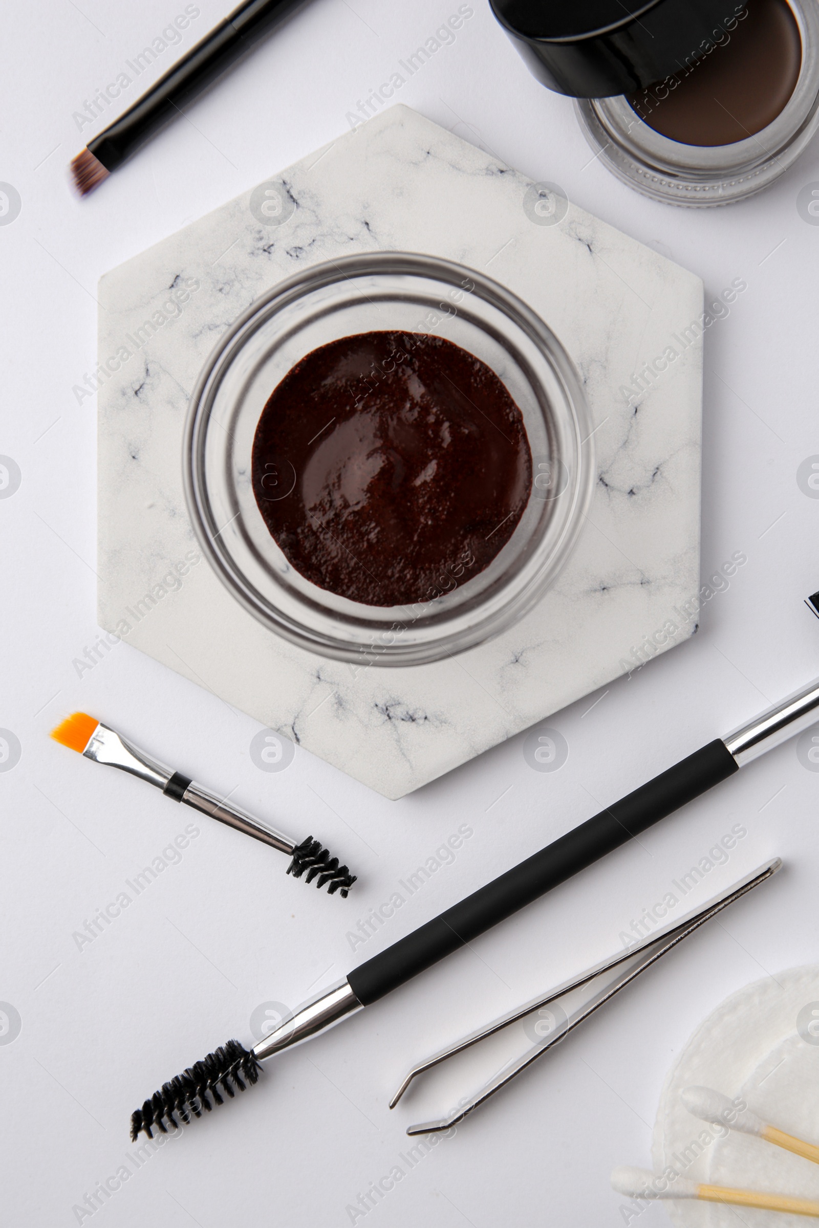 Photo of Flat lay composition with eyebrow henna and professional tools on white background