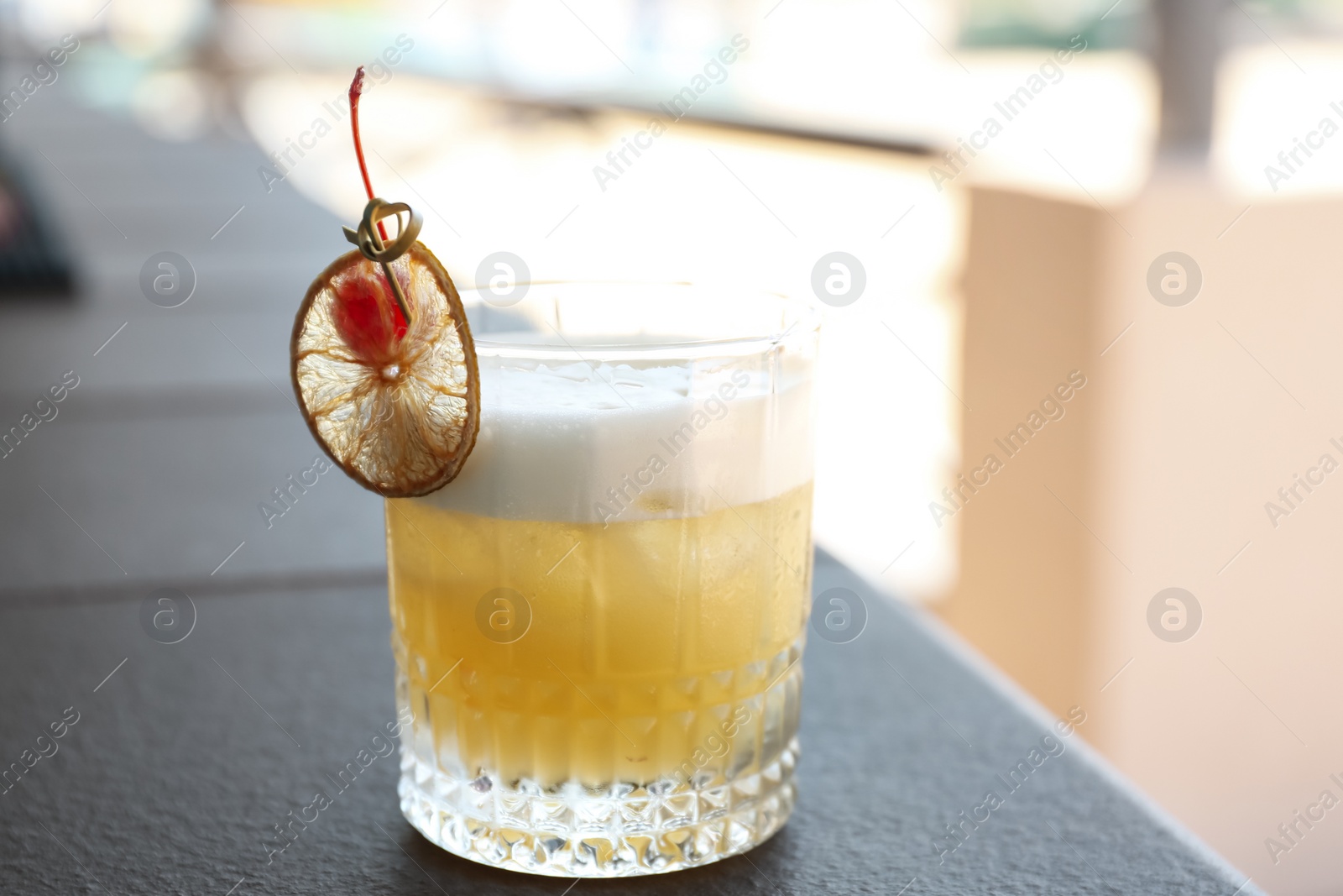 Photo of Delicious cocktail on table outdoors. Refreshing drink