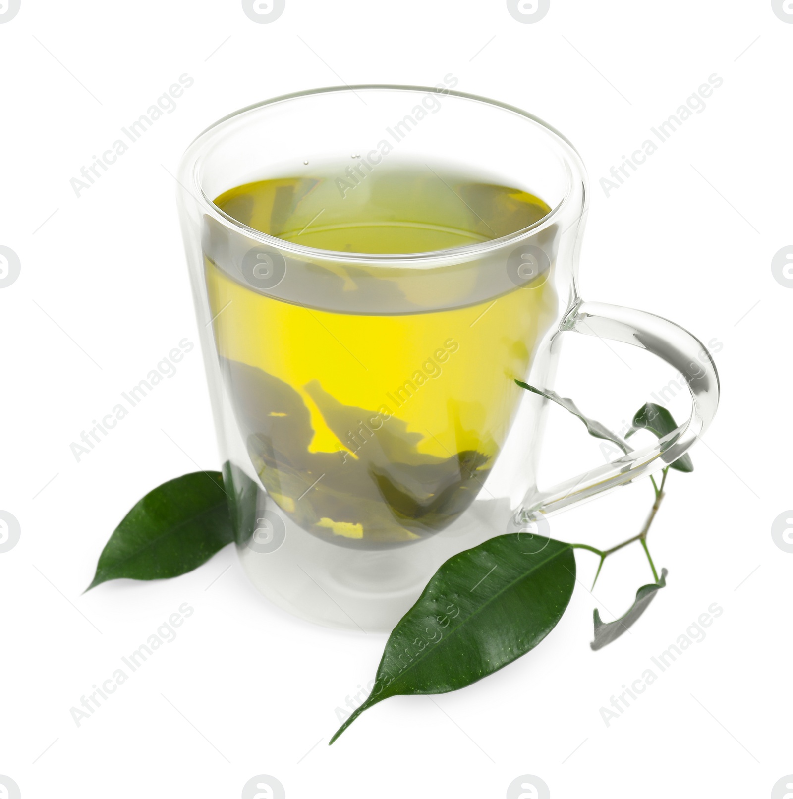 Photo of Fresh green tea in glass mug and leaves isolated on white