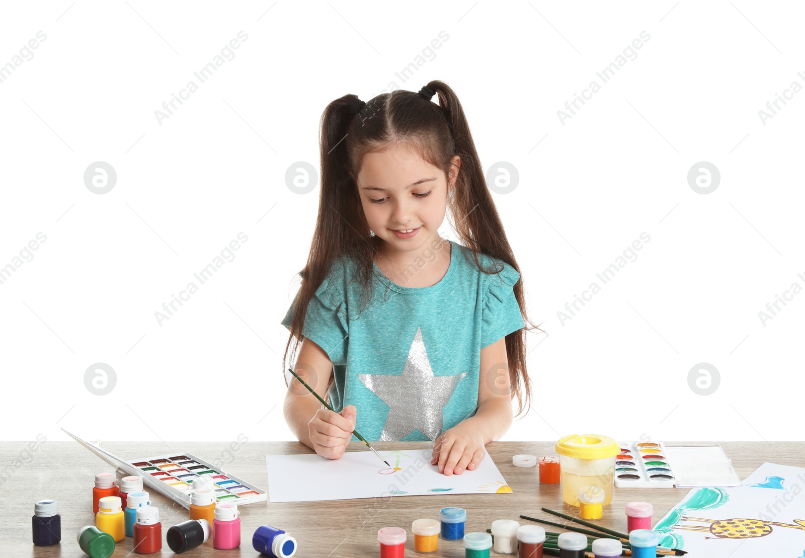 Photo of Cute child painting picture at table on white background