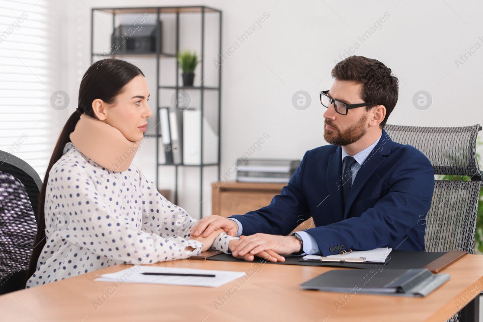 Photo of Injured woman having meeting with lawyer in office