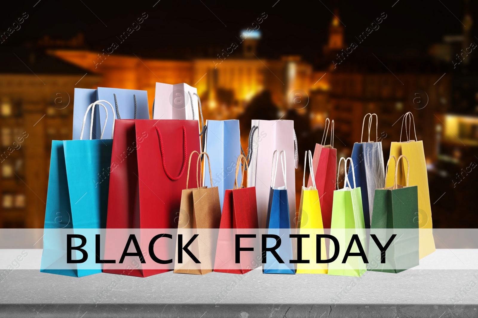Black Friday. Many shopping bags and blurred cityscape on background Image of Black Friday. Many shopping bags and blurred cityscape on background