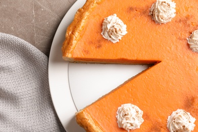 Photo of Fresh delicious homemade pumpkin pie with whipped cream on table, top view