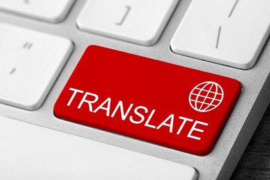 Image of Red button with word TRANSLATE on computer keyboard, closeup view