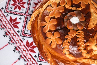 Photo of Korovai on rushnyk, above view. Ukrainian bread and salt welcoming tradition