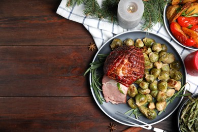 Photo of Festive flat lay composition with delicious ham on wooden table, space for text. Christmas dinner