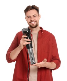 Photo of Smiling man holding sous vide cooker on white background