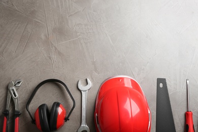 Photo of Flat lay composition with construction tools on grey background, space for text