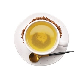 Cup of aromatic buckwheat tea and granules on white background, top view