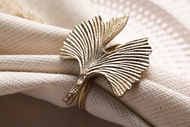 Photo of Fabric napkin and decorative ring on plate, closeup