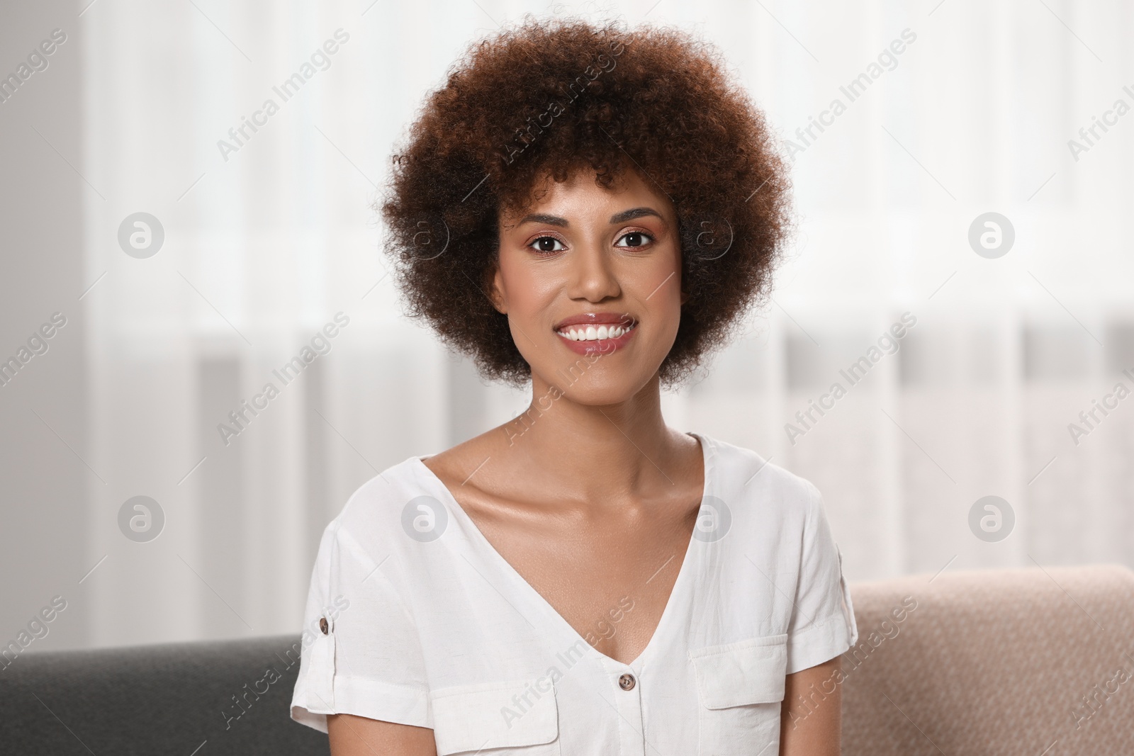 Photo of Portrait of beautiful young woman near window indoors