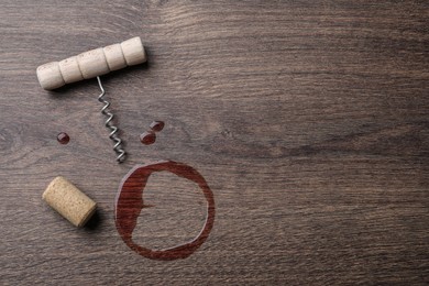 Photo of Wine stain, corkscrew and stopper on wooden table, flat lay. Space for text