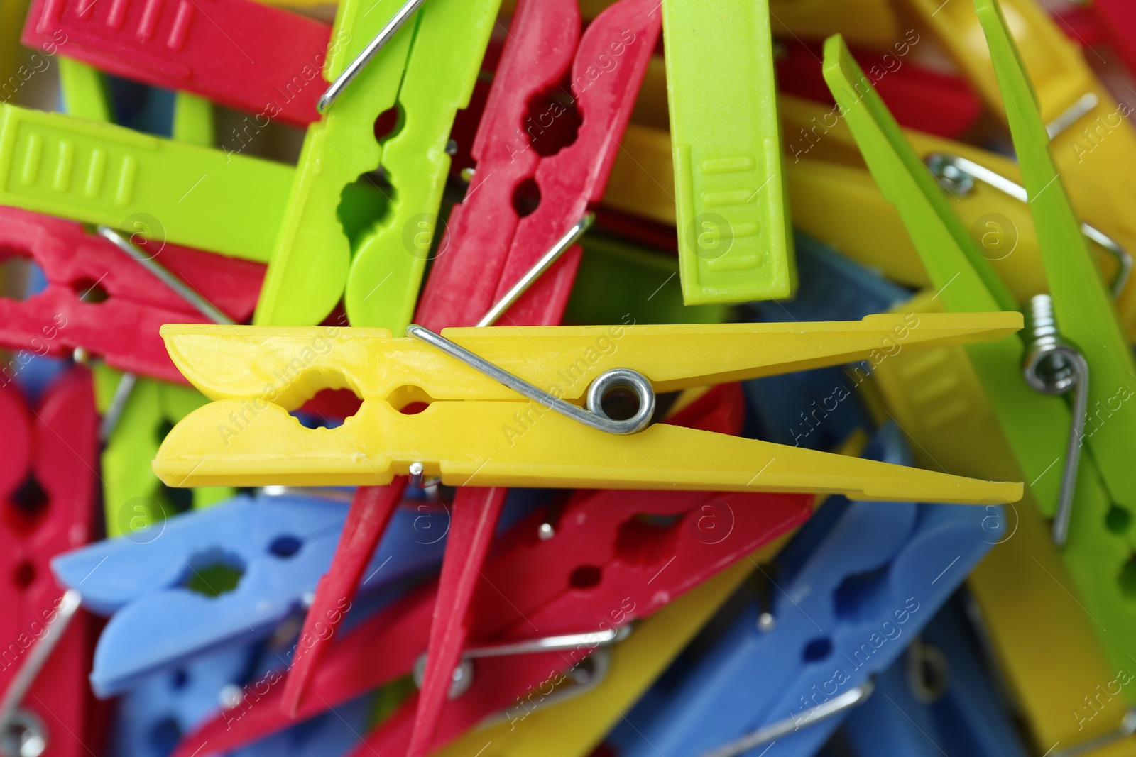 Photo of Colorful plastic clothespins as background, top view