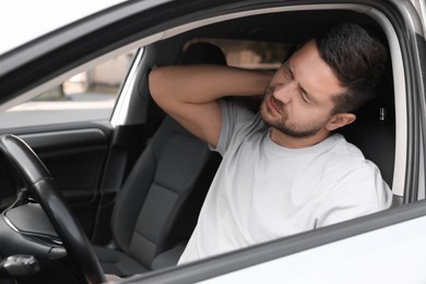 Photo of Man suffering from neck pain in car